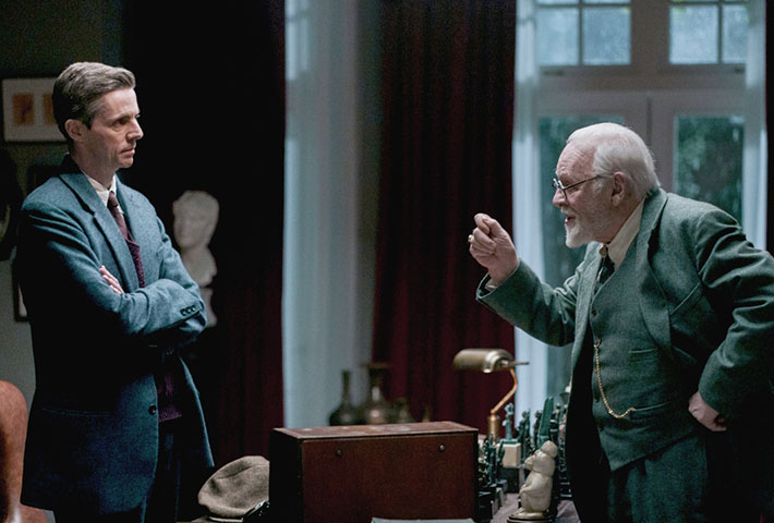 Matthew Goode and Sire Anthony Hopkins inside talking.