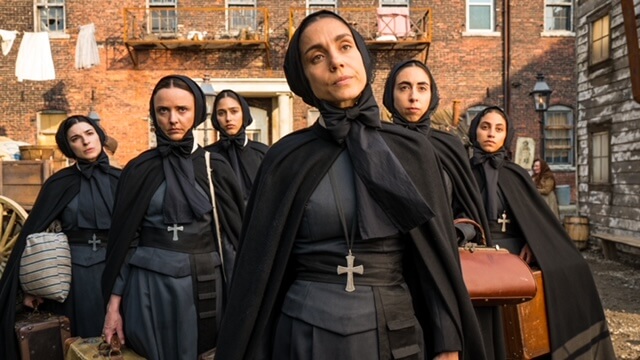 Cristiana Dell'Anna (center) as Francesca Cabrini walking outside with a group of nuns.