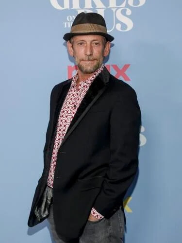 PJ Sosko in a blazer and hat at an event.