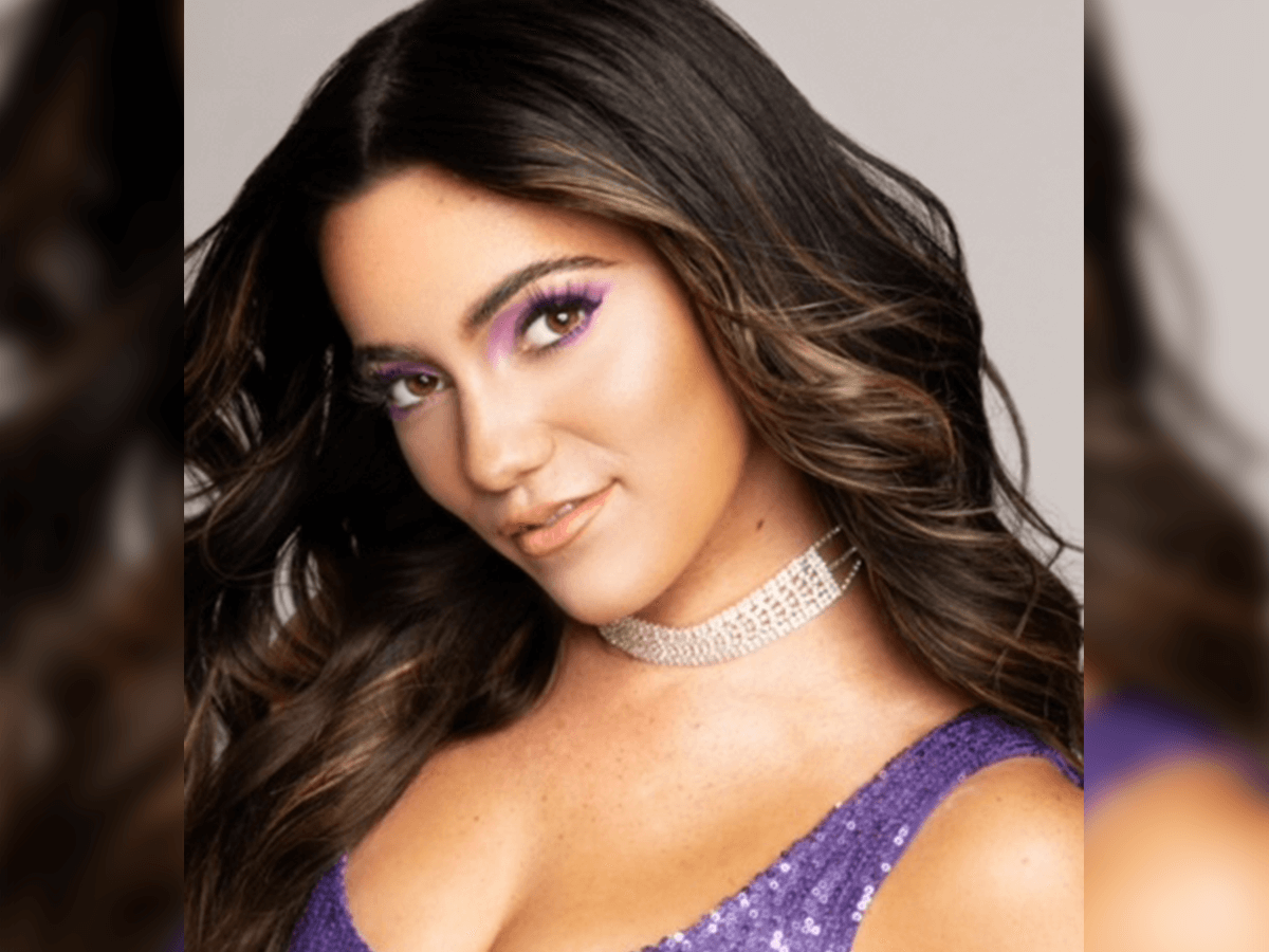 Liana Ramirez in a purple shirt smiling.